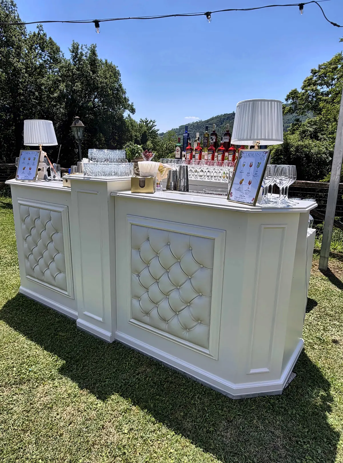 Bar in the sun under string lights, daytime wedding near Lucca