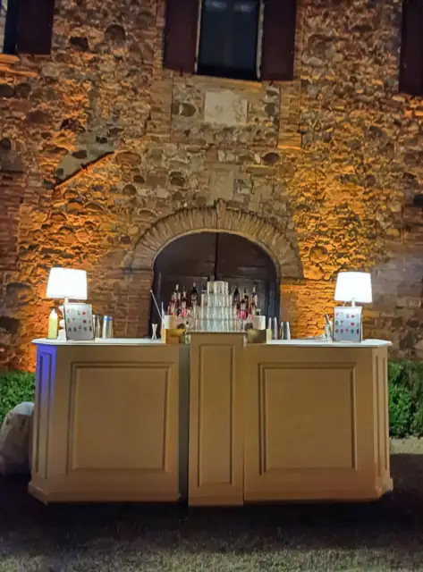 Evening bar in front of the stone façade of Borgo di Castelvecchio