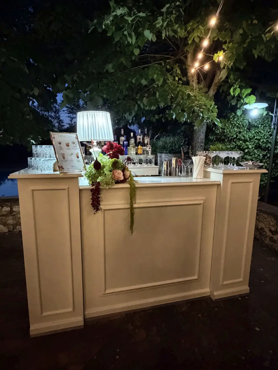 The flower-decked bar under string lights at Borgo Santinovo