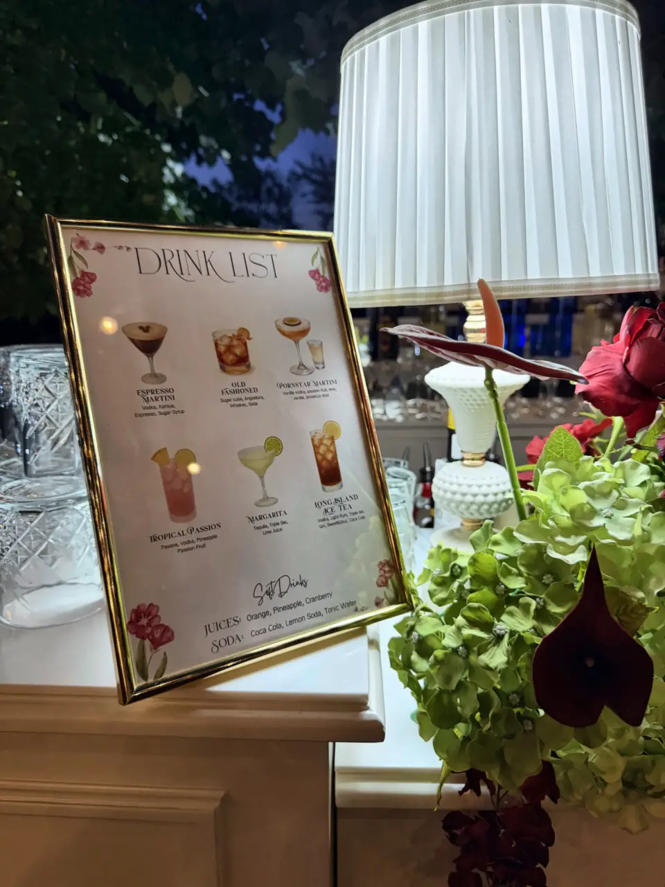 The wedding drink list among flowers and lamp