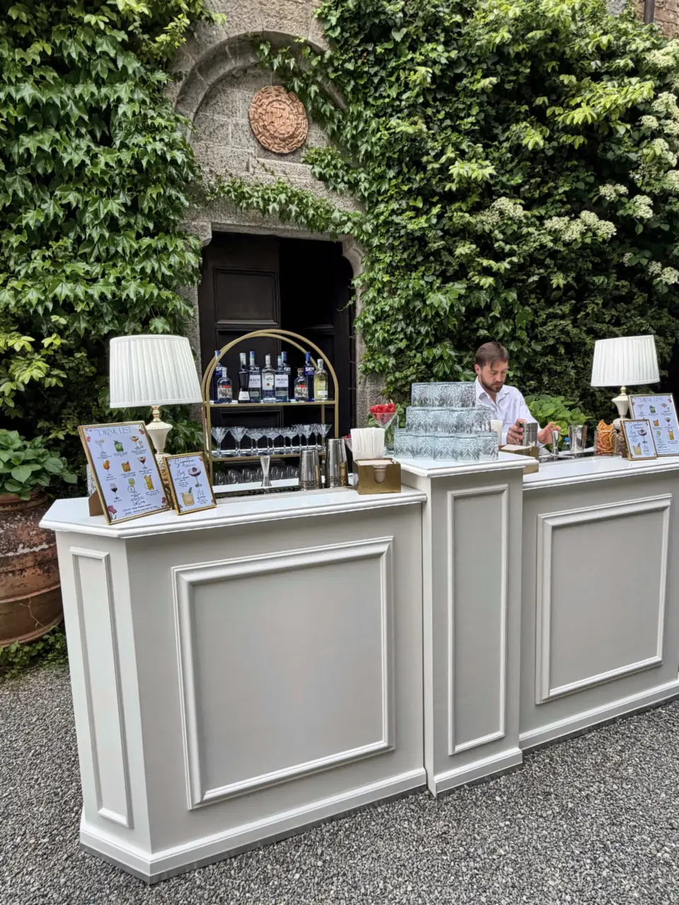 Bartender behind the white bar at Castello di Montalto