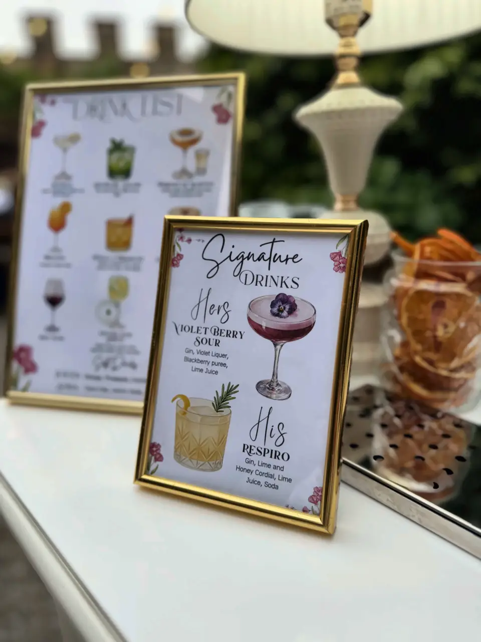 Wedding drink list and his-and-hers signature cocktails in gold frames