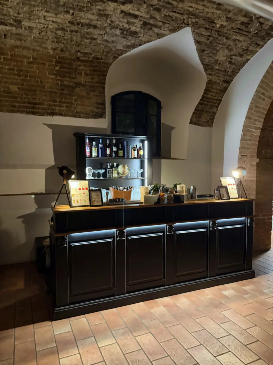 Black wedding bar in the vaulted brick cellar of Certosa di Pontignano, Siena