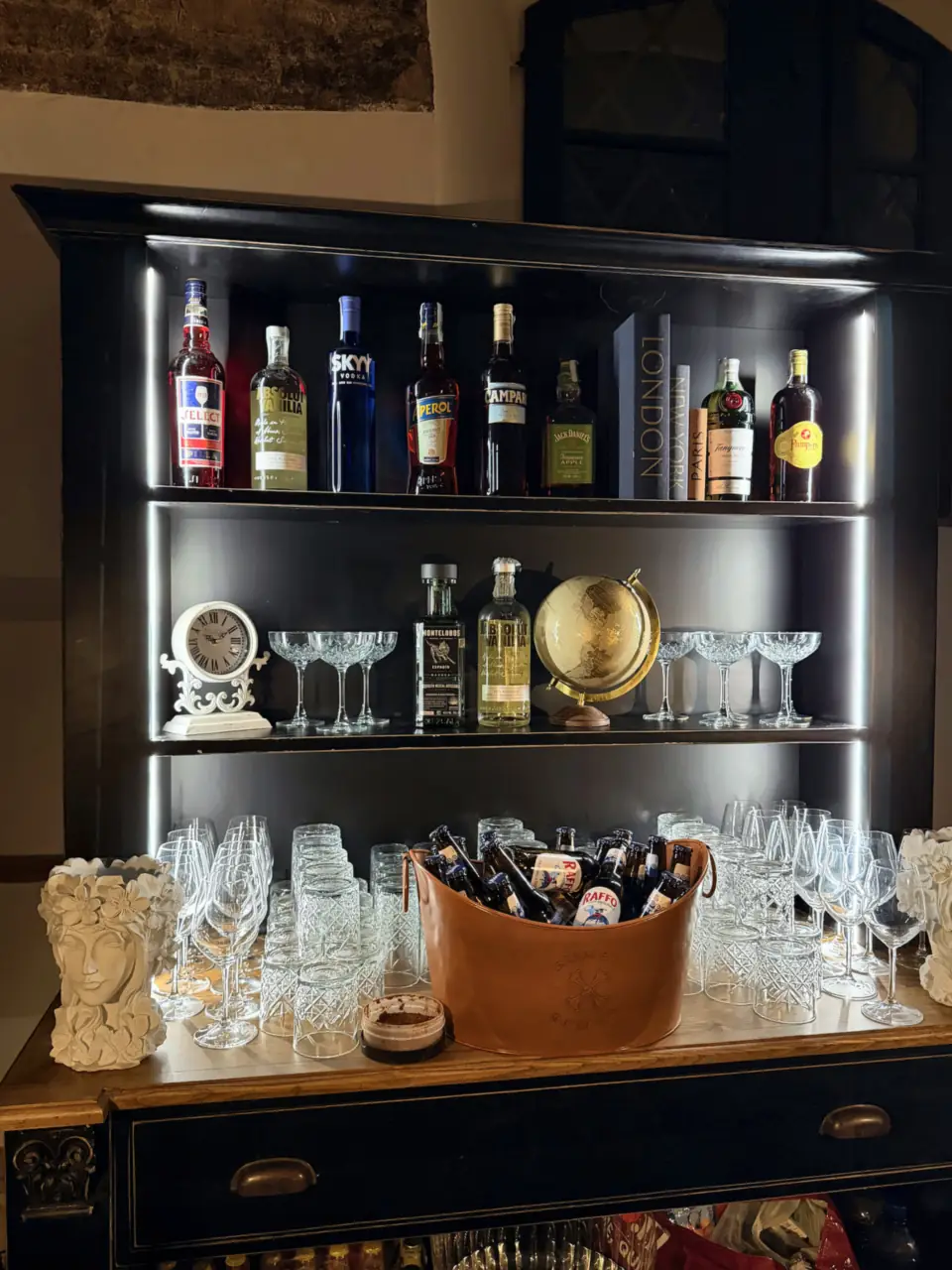 Lit back bar and crystal glassware of the black bar