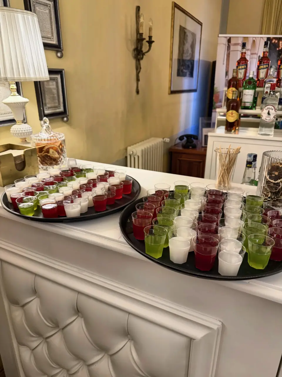 Coloured shots ready on a white padded wedding bar, Villa Alta, Pisa