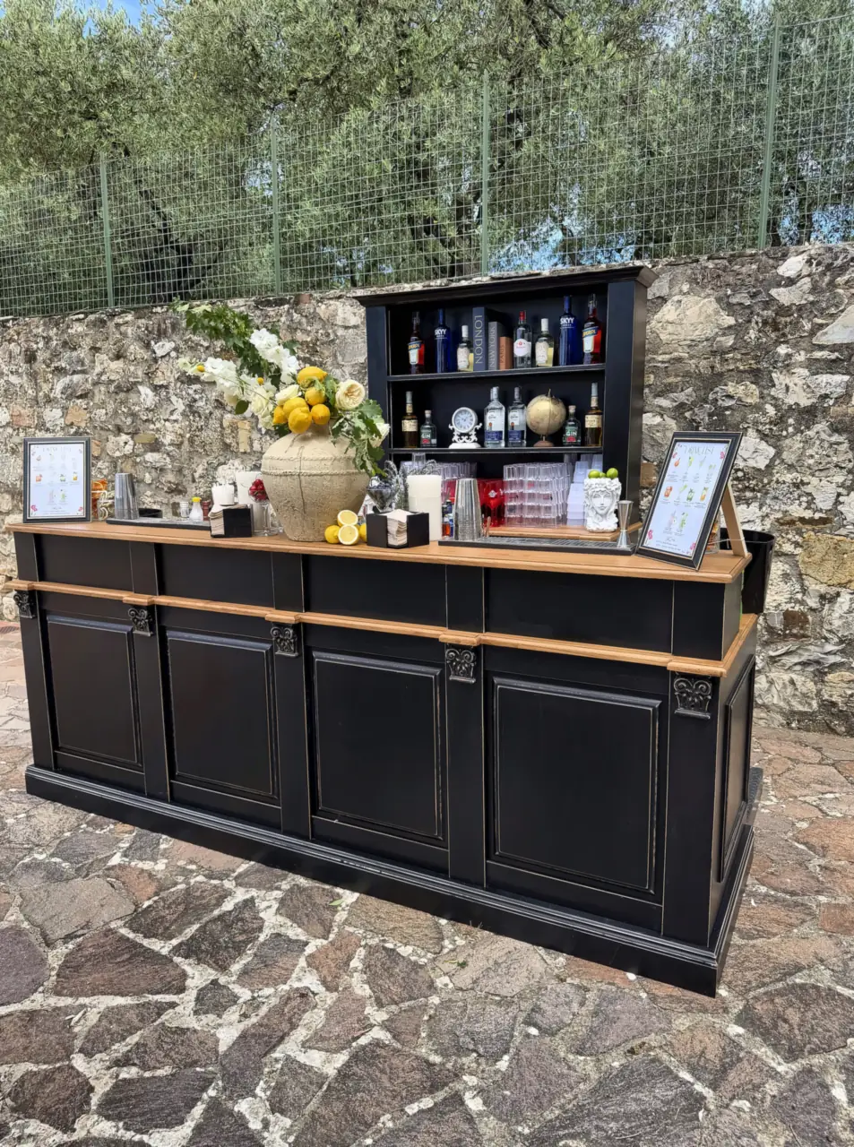 Black wedding bar on the stone terrace of Villa Catignano, among olive trees