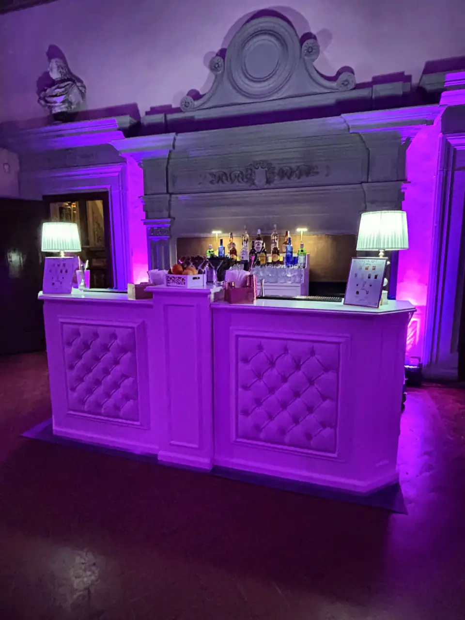 Bar in the hall of Villa Corsini lit in purple for the party