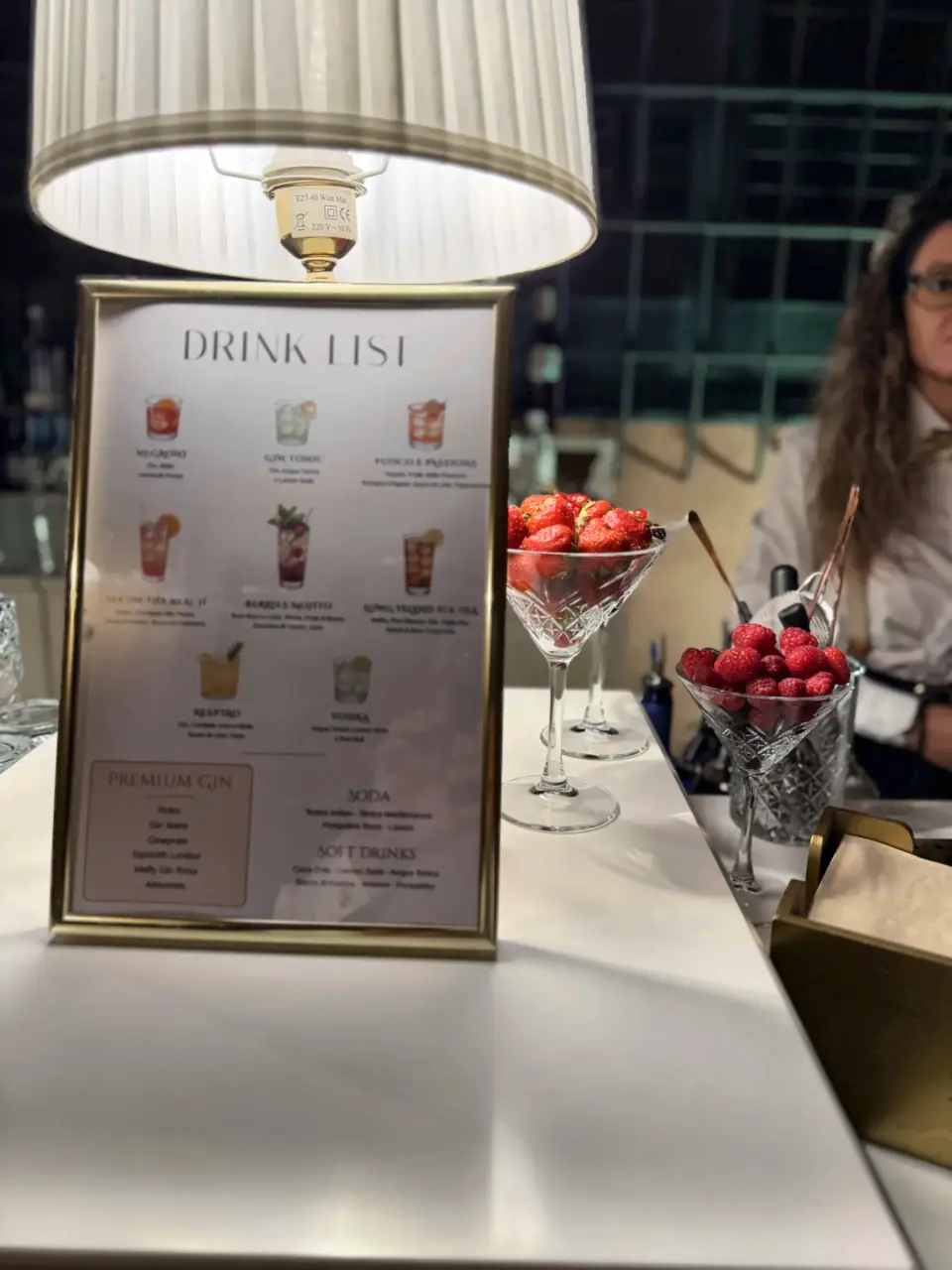 The wedding drink list in a gold frame on the bar