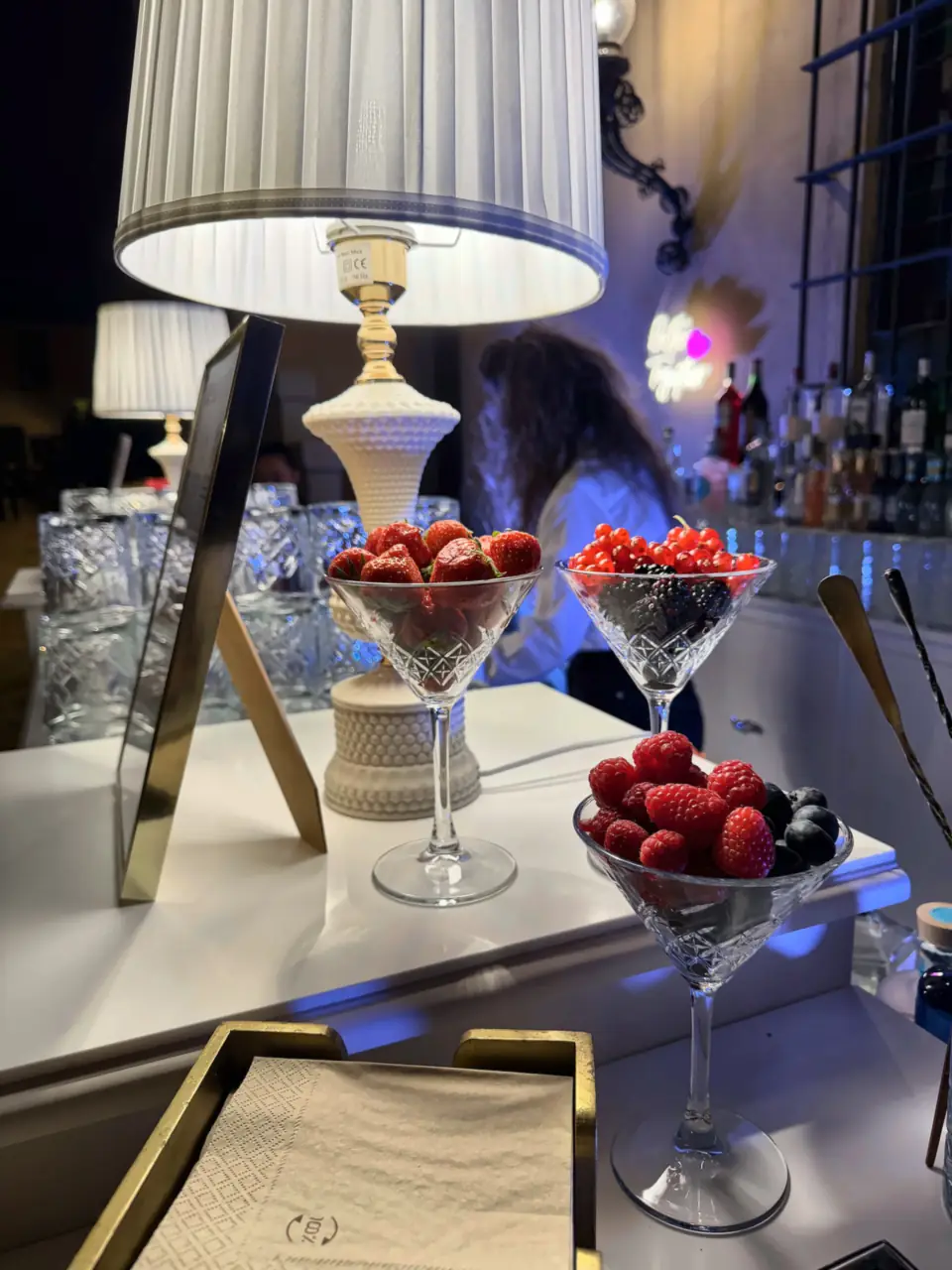 Strawberries and berries in crystal coupes for cocktails